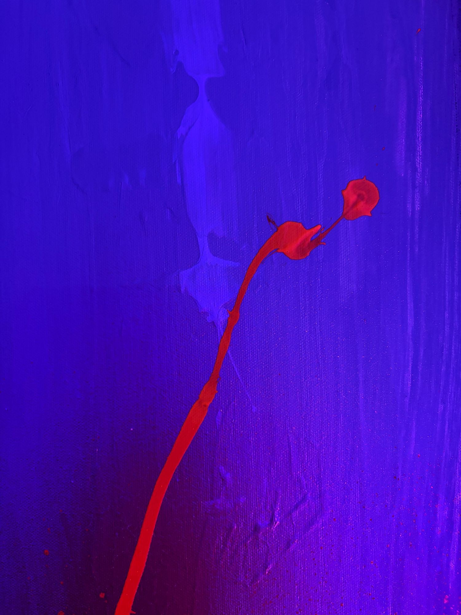 A red stem rising through deep blue and violet paint