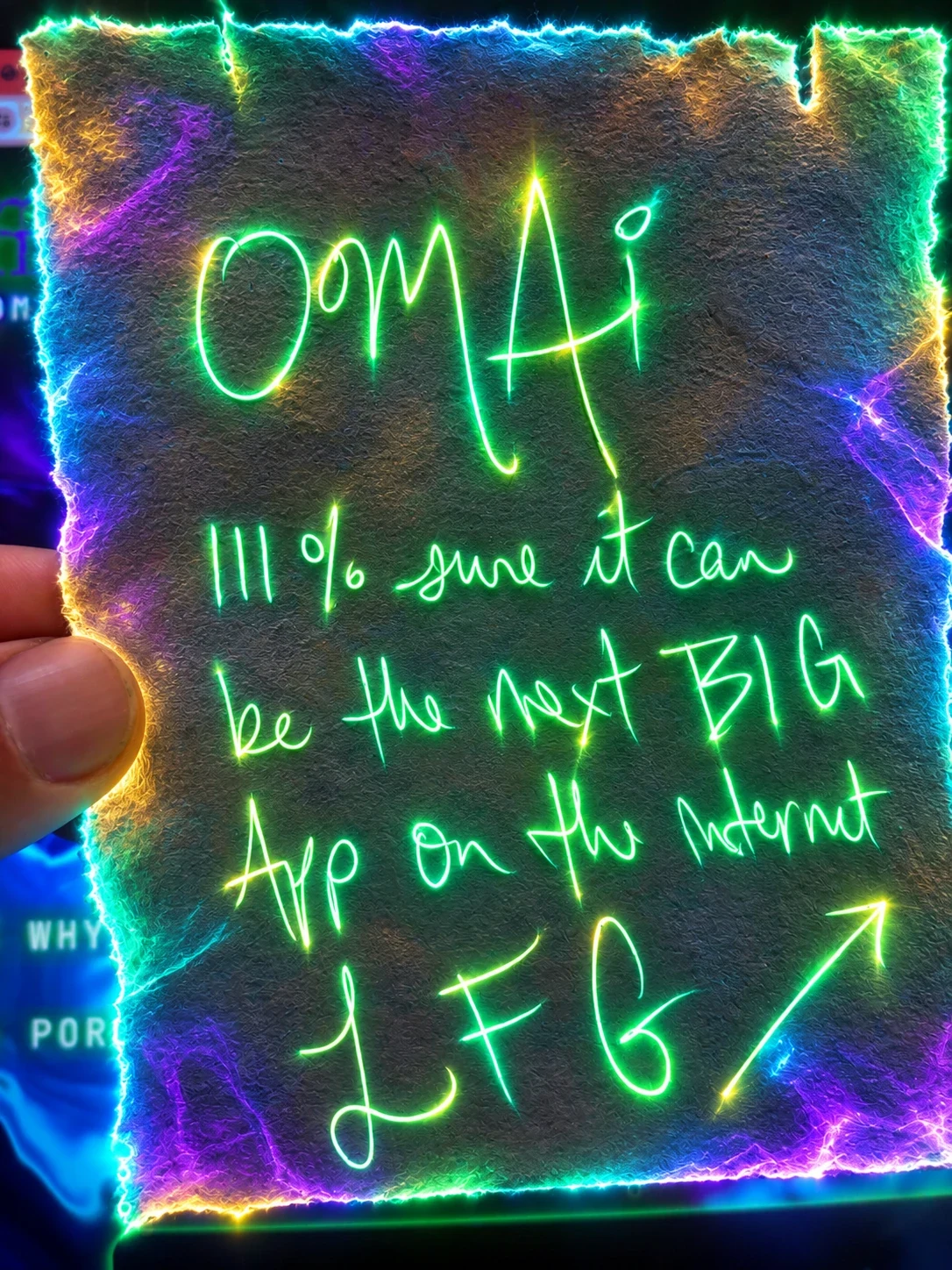 A handwritten note glowing in neon green light that reads: OMAI, 111% sure it can be the next big app on the internet, LFG, with an arrow pointing up and to the right